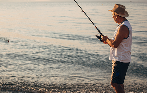 person casting line next to body of water